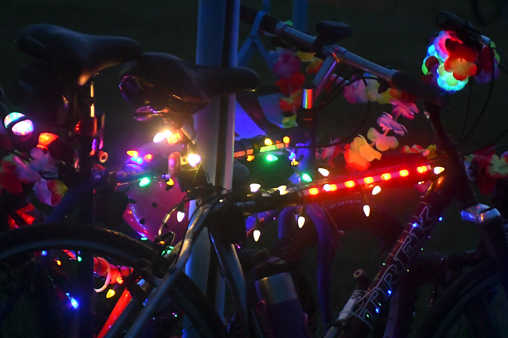 Glow sticks wrap around the bikes people brought to the park Saturday